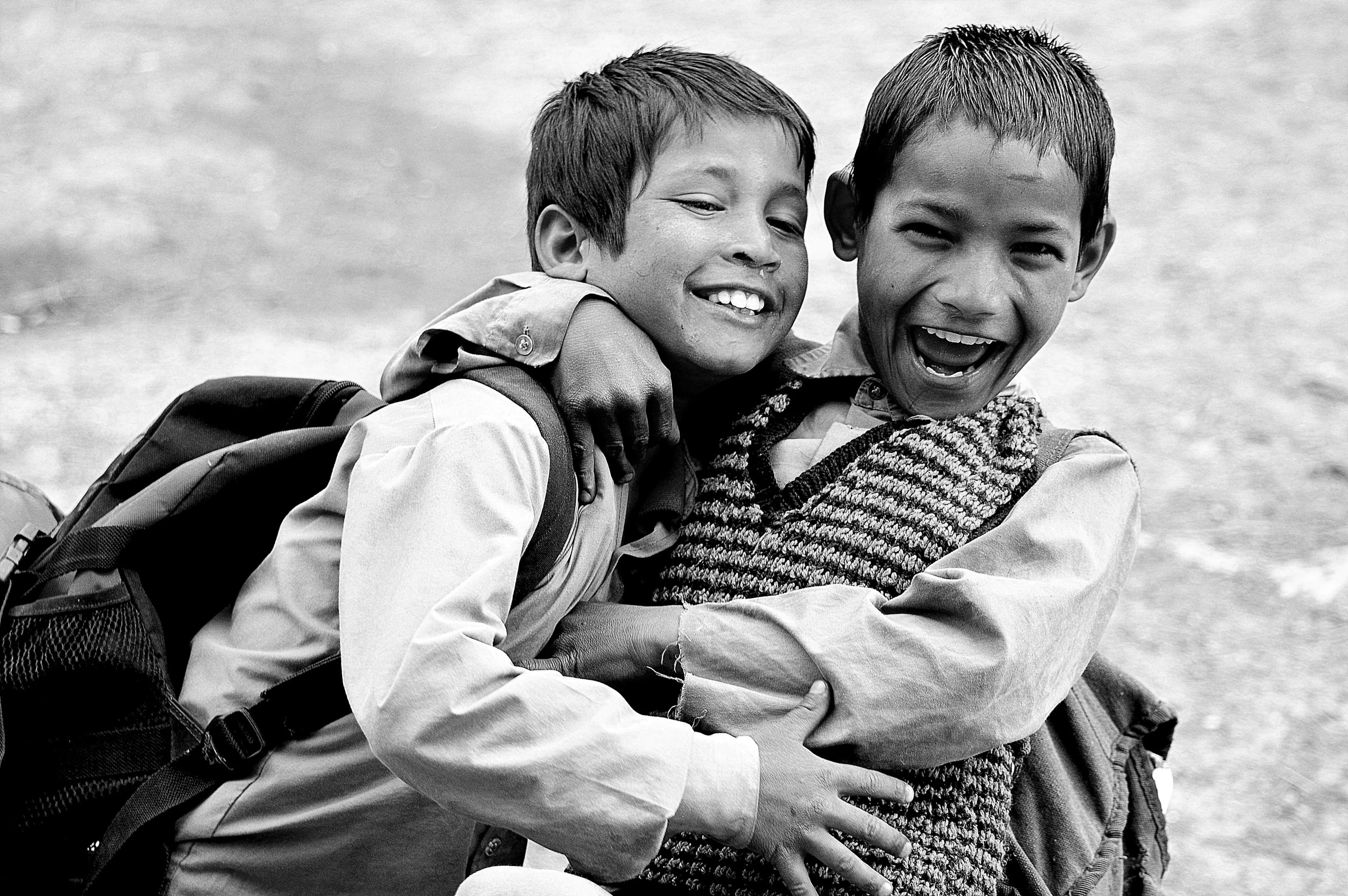 Two smiling children embracing each other